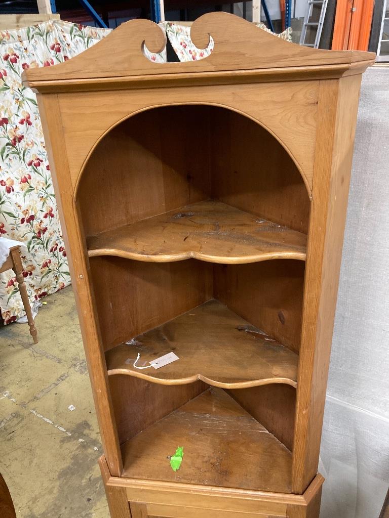 A pine standing corner cabinet, height 180cm